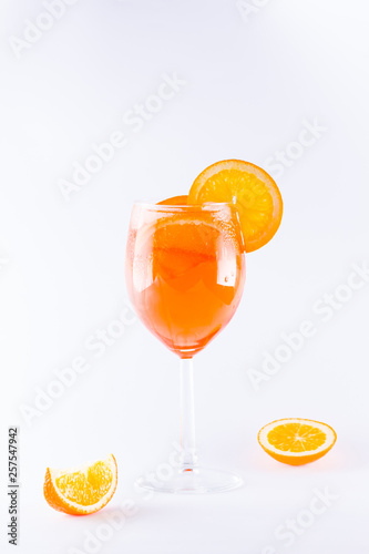 Cocktail aperol spritz on white background. Summer alcoholic cocktail with orange slices. Italian cocktail aperol spritz on white. Isolated