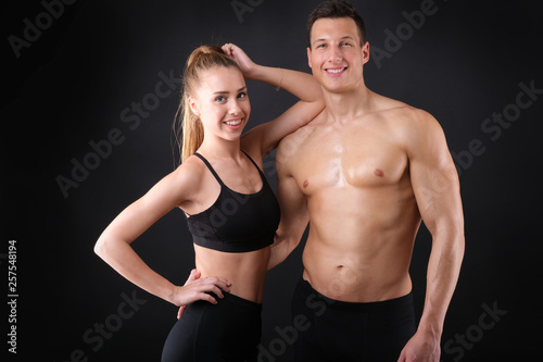 Fitness young man and woman isolated on black background. © forma82