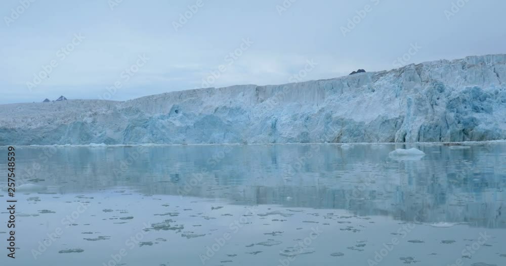 Sailing near large blue Iceberg Beautiful shot of sailing near large blue Iceberg and mountains in the arcticin 4K resolution Sailing near large blue Iceberg Beautiful shot of sailing near large blue Iceberg and mountains in the arcticin 4K resolution