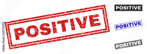 Grunge POSITIVE rectangle stamp seals isolated on a white background. Rectangular seals with grunge texture in red, blue, black and grey colors.
