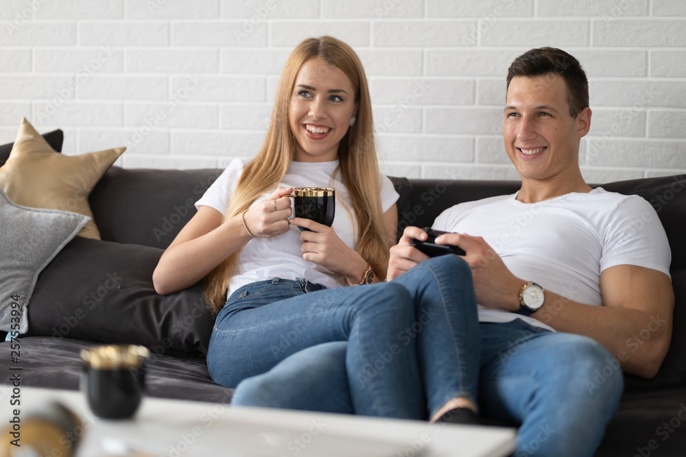 Young couple spending time together at home drinking coffee and talking. Young couple spending time together at home drinking coffee and talking.