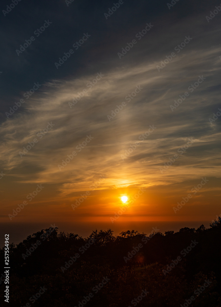 Fototapeta premium View of the beautiful sunset over the Black Sea coast from the observation tower from Mount Akhun in Sochi, Russia