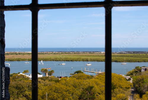 Looking out a window into a harbor from a high vantage point © Steve Samoyedny