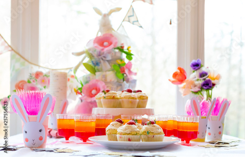 Dessert table with cupcakes and flowers Easter party theme photo