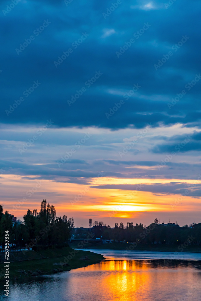 Sunset over Uzh river in Uzhhorod city, Transcarpathia region, Ukraine. Beautiful cityscape of old european town