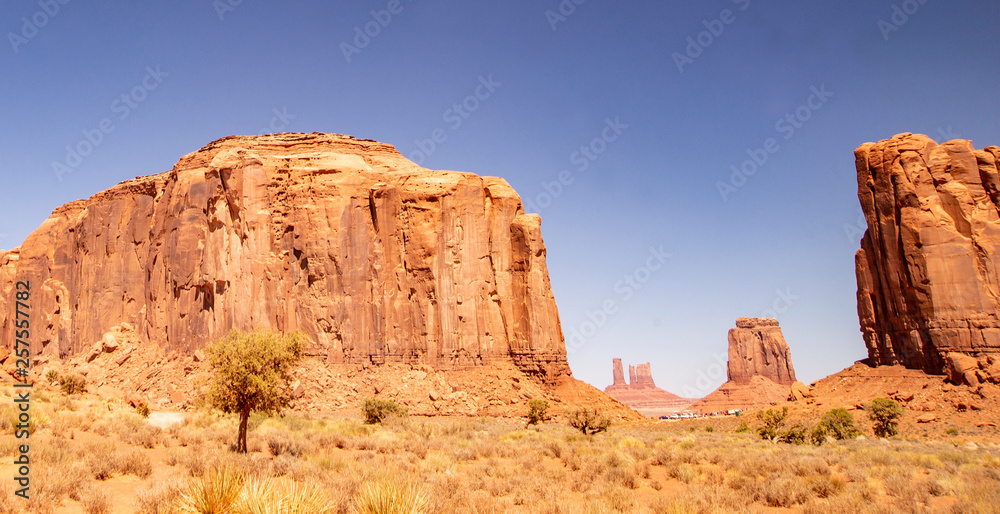 Monument Valley famous rock formations under a blue sky. Monument Valley famous rock formations under a blue sky.