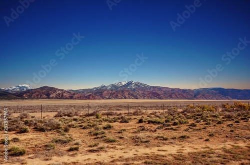 Along the road in Southern Utah with mountain peaks in the distance 