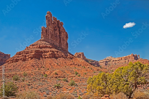 Monument Valley famous rock formations under a blue sky.