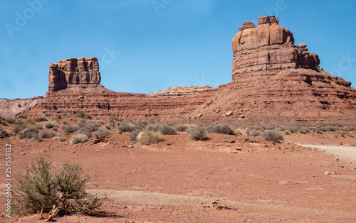 Monument Valley famous rock formations under a blue sky.