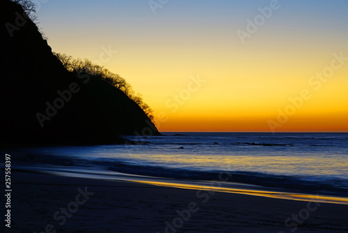 Dramatic orange sunset sky over the Playa Virador beach in Peninsula Papagayo, Guanacaste, Costa Rica photo