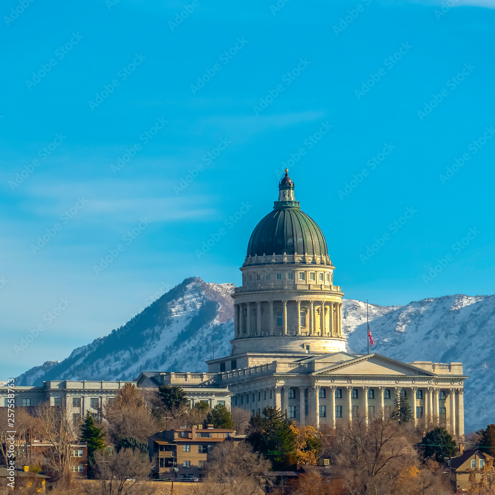 Utah State Capital Building against snowy mountain