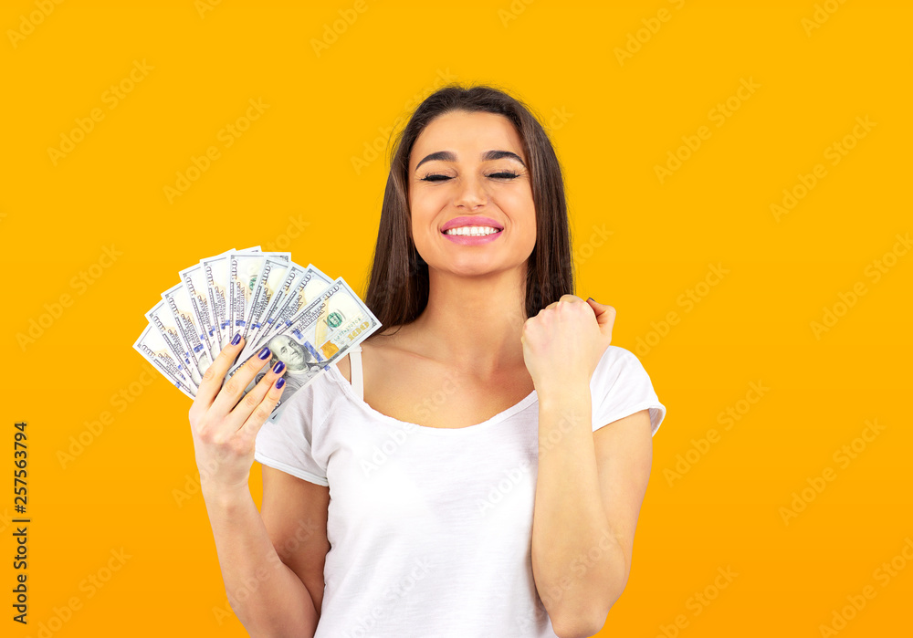 cheerful woman holding money and celebrating success cheerful woman holding money and celebrating success
