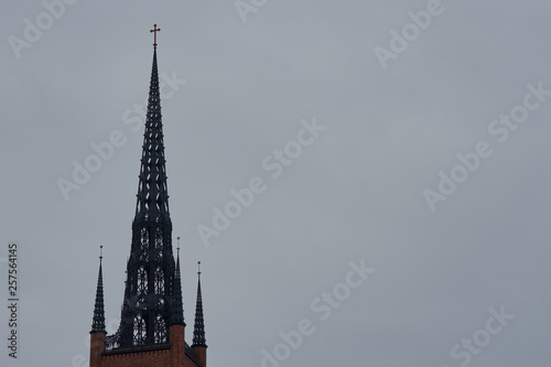                                Clocktower of Stockholm Cathedral - Riddarholmskyrkan church against a cloudy sky. Copy space.  © Arthur