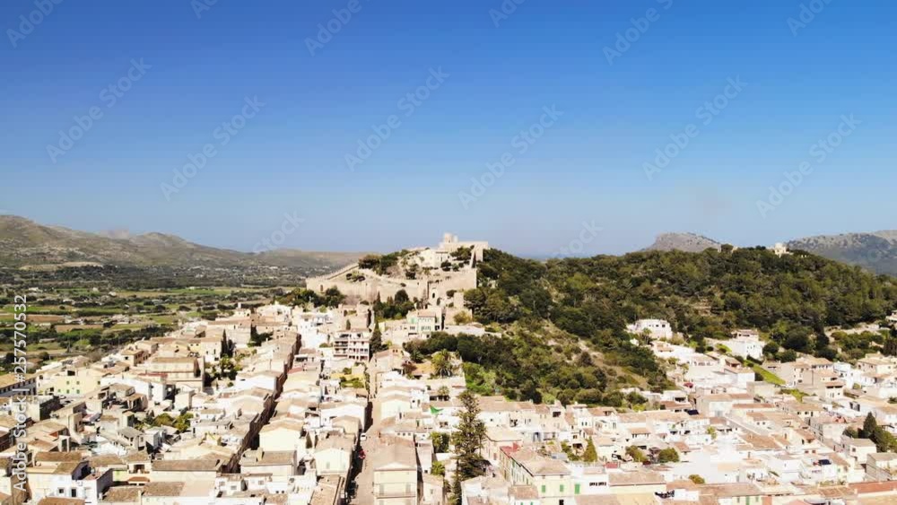 a left rotating drone shot of castle capdepera from across the town of Capdepera in Majorca a left rotating drone shot of castle capdepera from across the town of Capdepera in Majorca