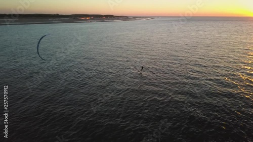 Kitesurfer using a hydrofoil during a sunset in Zeeland, the Netherlands.