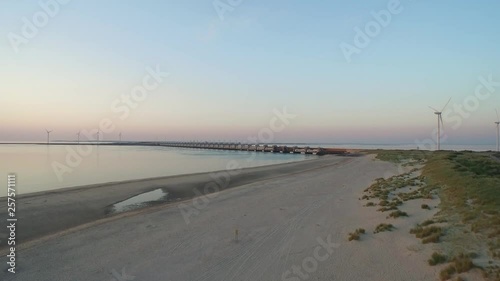 Aerial: The beach around the Oosterschelde storm surge barrier during  a summer sunset. photo