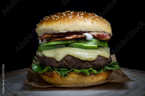 Cheeseburger with bacon  avocado  lettuce and mayonnaise