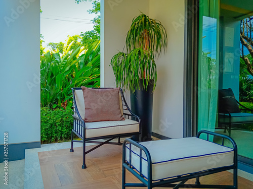 Outdoor patio with empty chair and table with nature view.