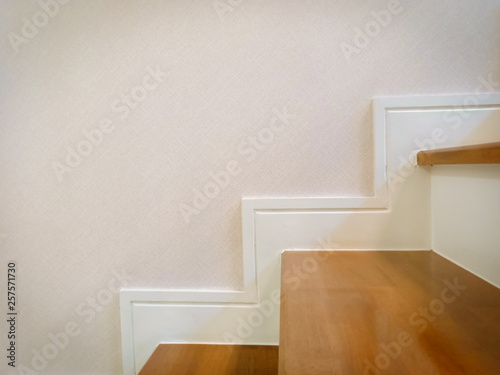 staircase in the house close-up, modern stair with wooden tread and white skirting on wall