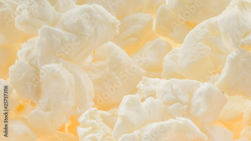 Popped buttered popcorn macro background - amazing detail and texture of fluffy popped kernels