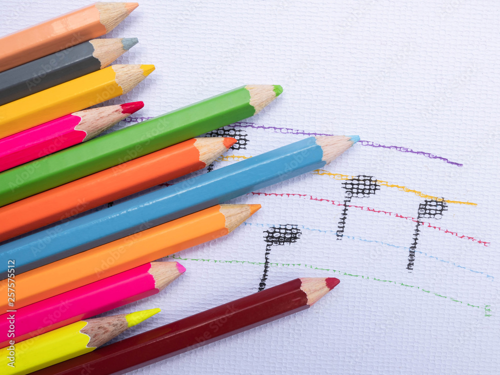 Color pencils place on white paper background with Music note drawing. Education concept. Color pencils place on white paper background with Music note drawing. Education concept.