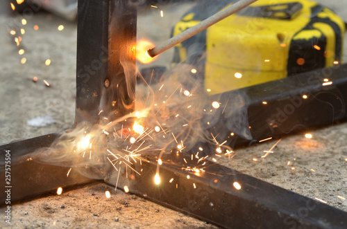 Spark from weld work when welder welding iron, steel structure in construction site, industrial metal workshop in factory, welding industry, iron industry, iron industrial, industrial welding process