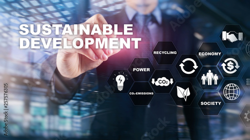 Sustainable development, ecology and environment protection concept. Renewable energy and natural resources. Double exposure of success businessman with abstract building.