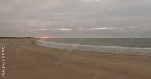 Aerial: An overcast beach during sunset in the Netherlands. photo