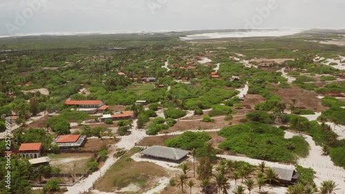 Aerial: The small village Atins in Northern Brazil. A village in the dunes without paved roads. photo