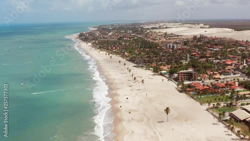 Aerial: Cumbuco during day with people kitesurfing.