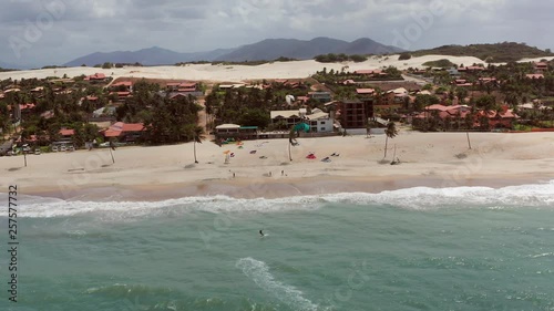 Aerial: Cumbuco during day with people kitesurfing. photo