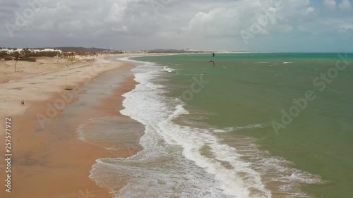 Aerial: Cumbuco during day with people kitesurfing. photo