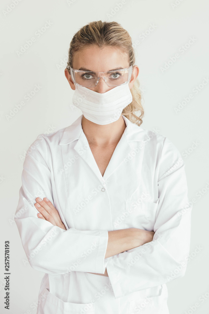 Female nurse, doctor or scientist wearing mouth mask - COVID-19 coronavirus pandemic themed Female nurse, doctor or scientist wearing mouth mask - COVID-19 coronavirus pandemic themed
