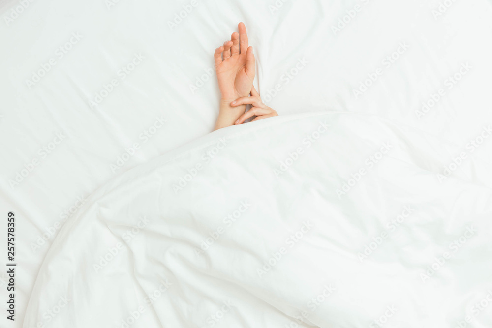 Caucasian Hands Peeking Out From Under Bedsheets Caucasian Hands Peeking Out From Under Bedsheets