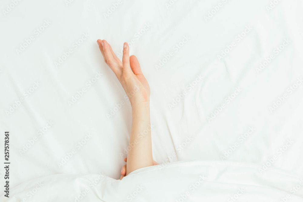 Caucasian Hands Peeking Out From Under Bedsheets Caucasian Hands Peeking Out From Under Bedsheets