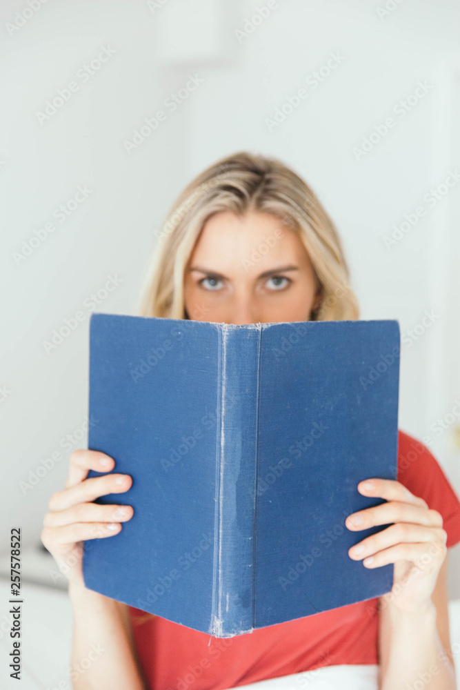 Blonde caucasian woman reading a book Blonde caucasian woman reading a book