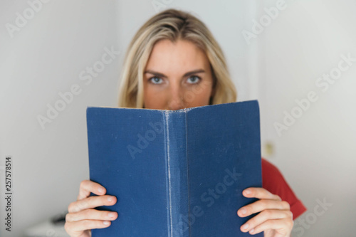 Blonde caucasian woman reading a book © TheCreativeBrigade