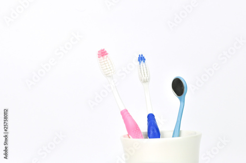 tooth brushes in glass