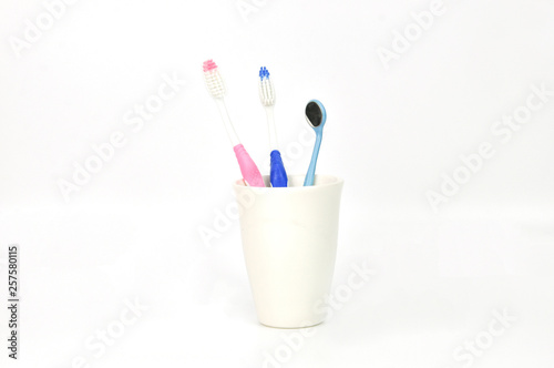 tooth brushes in glass