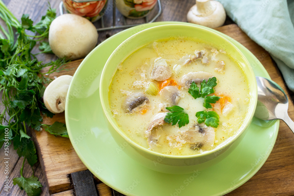 Cream soup with cream, chicken and mushrooms on a rustic-style kitchen table. American cuisine. Cream soup with cream, chicken and mushrooms on a rustic-style kitchen table. American cuisine.