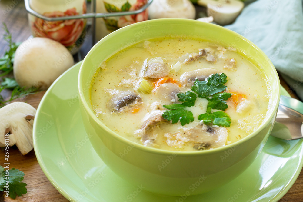 Cream soup with cream, chicken and mushrooms on a rustic-style kitchen table. American cuisine. Cream soup with cream, chicken and mushrooms on a rustic-style kitchen table. American cuisine.