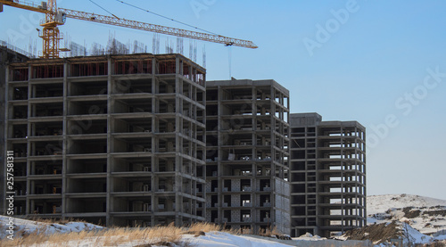 Buildings under construction. Kazakhstan (Ust-Kamenogorsk). Residential buildings. Construction crane. Cranes and buildings. New residential area. Construction site. Concrete frame. Housing estate