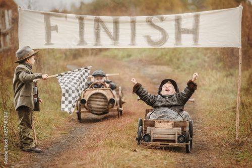 Finish the race between the boys on self-made cars photo
