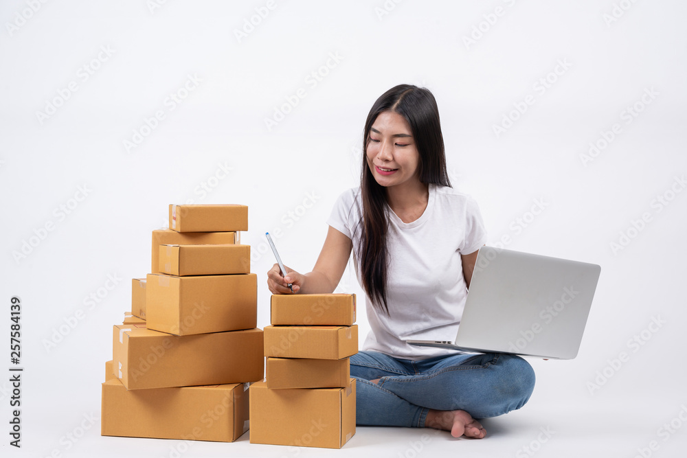 Happy women from ordering products from customers, business owners who work at home on a white background, Online shopping business operators Independent work concept. Happy women from ordering products from customers, business owners who work at home on a white background, Online shopping business operators Independent work concept.