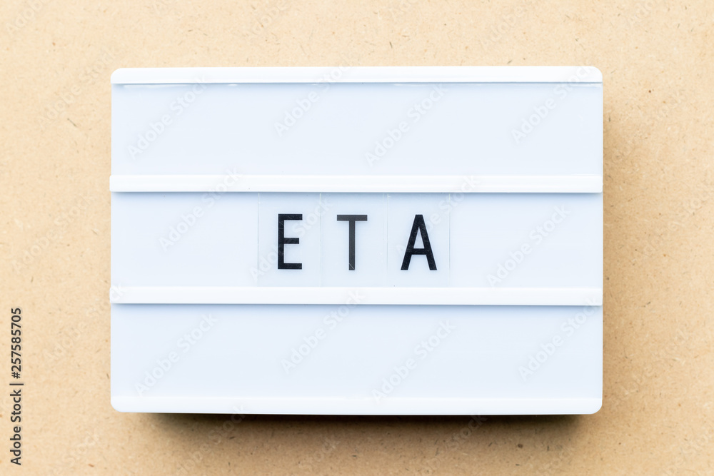 White lightbox with word ETA (abbreviation of Estimated time of arrival) on wood background White lightbox with word ETA (abbreviation of Estimated time of arrival) on wood background