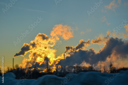 Obraz na płótnie air pollution from multiple pipes at sunset in winter w salonie