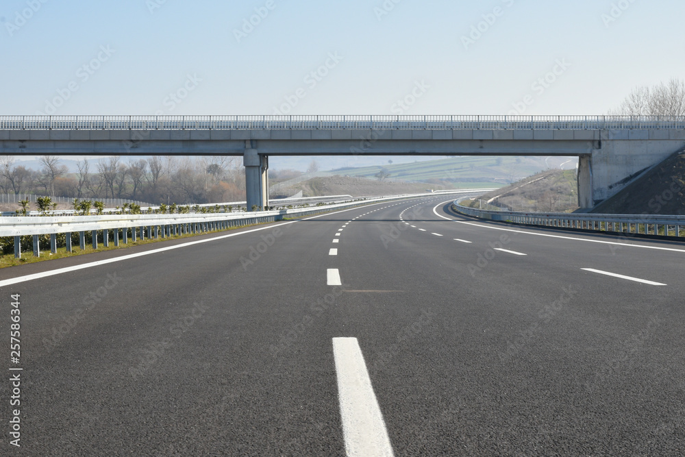 Construction of newly finished, empty highway. - obrazy, fototapety, plakaty 