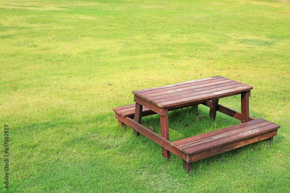 Wooden table and chairs set on green lawn in the garden. Wooden table and chairs set on green lawn in the garden.