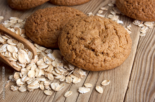 Oatmeal cookies with oat flakes with a wooden spoon. healthy food. on a wooden table