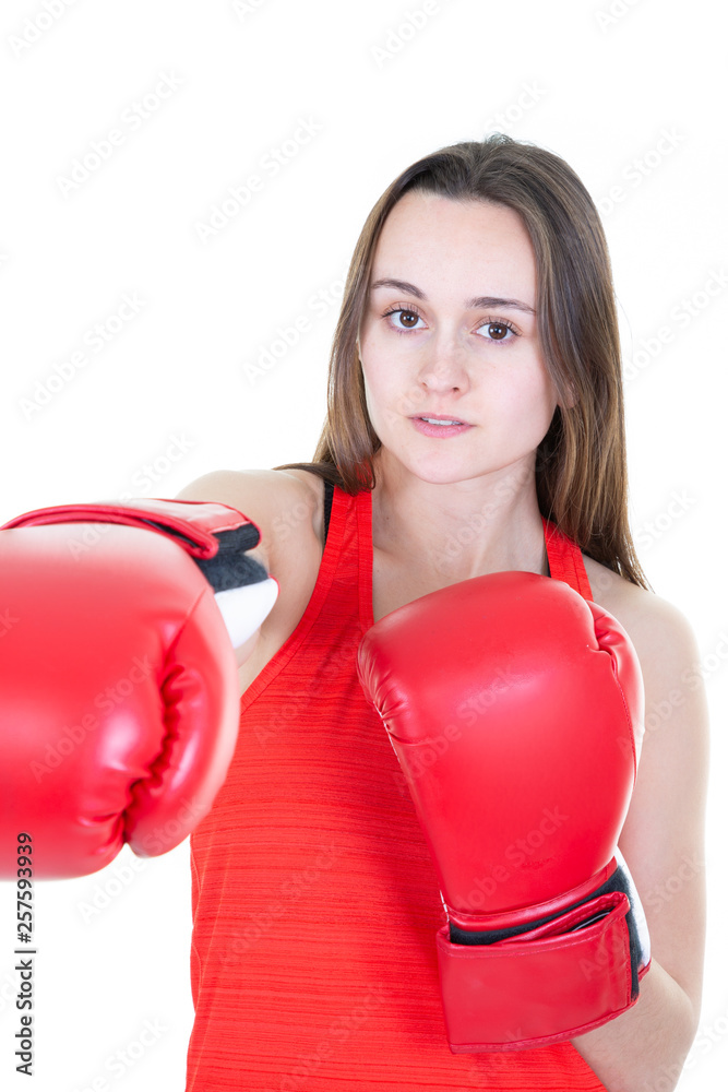 Boxer woman during boxing exercise making direct hit with red glove Boxer woman during boxing exercise making direct hit with red glove